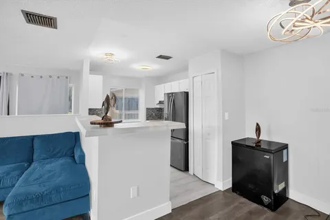 a view of kitchen with refrigerator microwave and cabinets