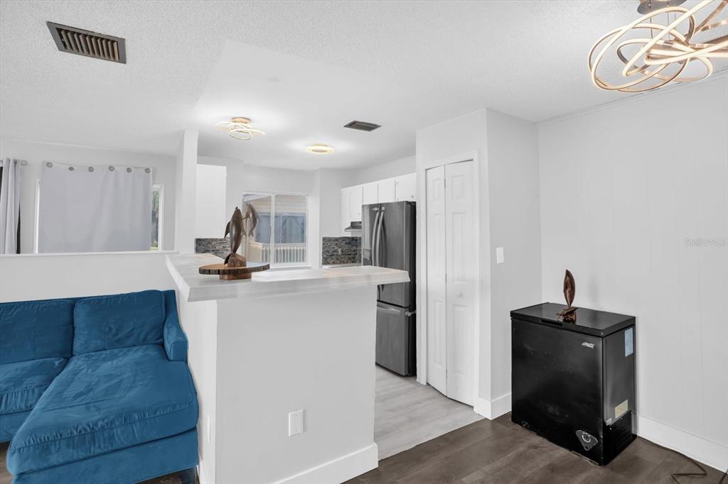 1121 Spring Meadow Drive, Unit 11221 Kissimmee, FL 34741 - Photo 8 of 28 a view of kitchen with refrigerator microwave and cabinets