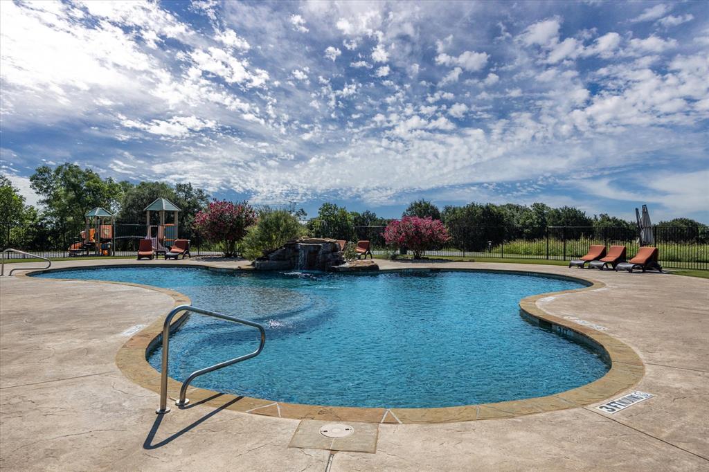 7308 Castle Royle Court Cleburne, TX 76033 - Photo 11 of 35 View of pool with pool water feature and a playground