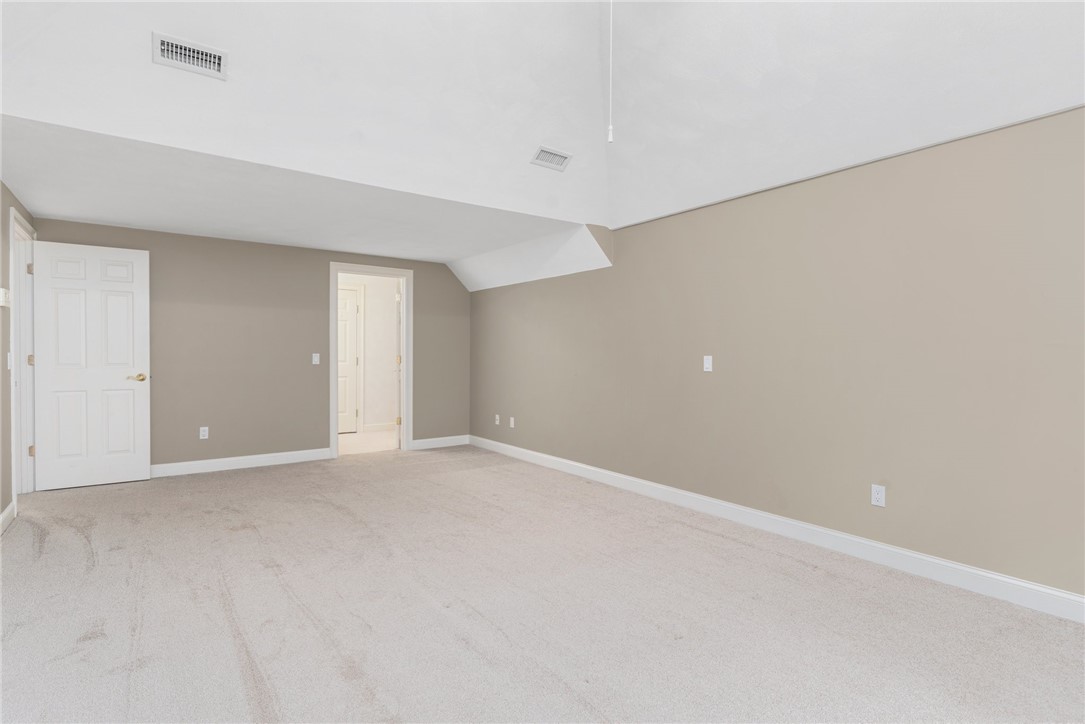 132 Channel View, Unit 3 Warwick, RI 02889 - Photo 38 of 50 Upstairs bedroom w/vaulted ceiling, walk-in closet and access to walk-in attic storage.