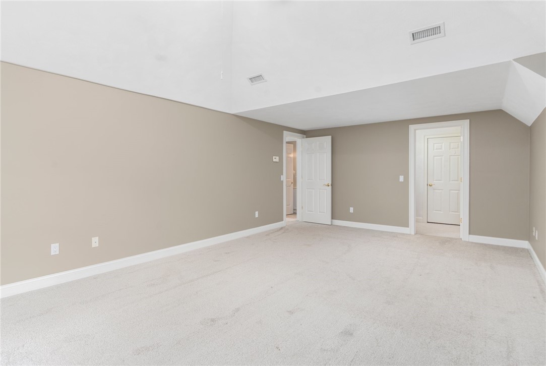 132 Channel View, Unit 3 Warwick, RI 02889 - Photo 39 of 50 Upstairs bedroom w/vaulted ceiling, walk-in closet and access to walk-in attic storage.