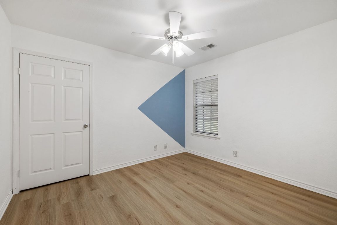 805 Sabinas Court Georgetown, TX 78628 - Photo 16 of 28 Bedroom 2 also has LVP flooing & room for a queen sized bed.