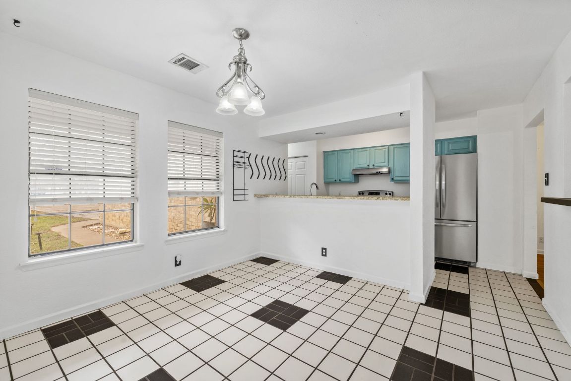 805 Sabinas Court Georgetown, TX 78628 - Photo 10 of 28 The dining room has large windows letting in the natural light.