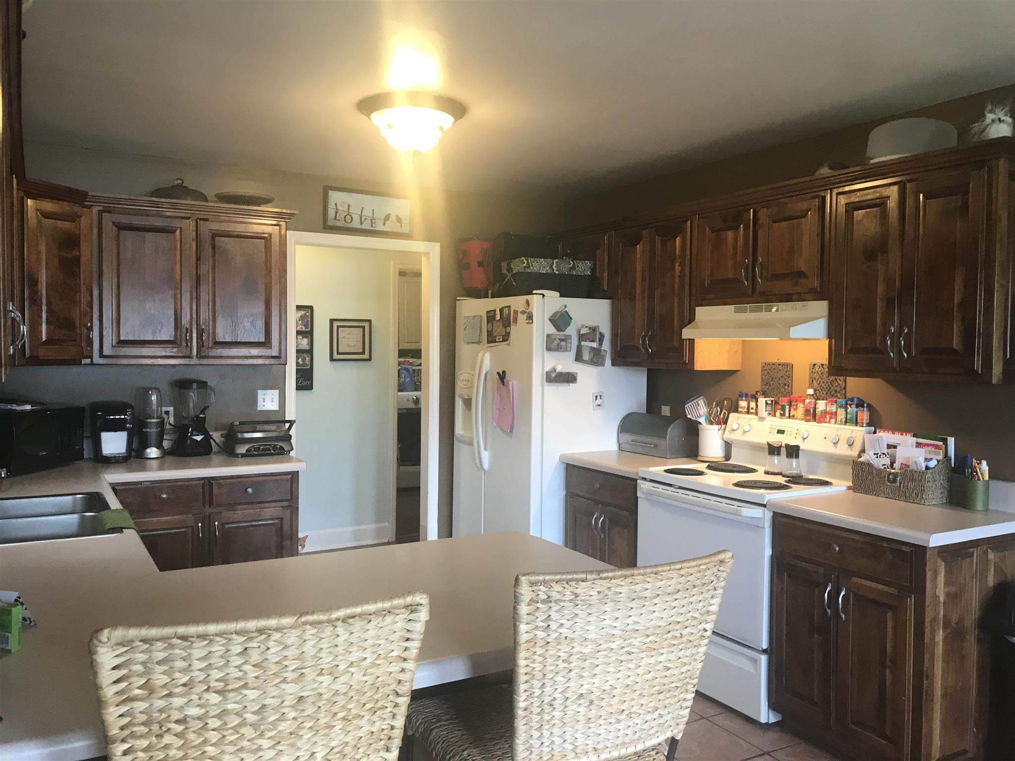 501 Rock Road Morrison, TN 37357 - Photo 8 of 22 a kitchen with refrigerator cabinets and wooden floor
