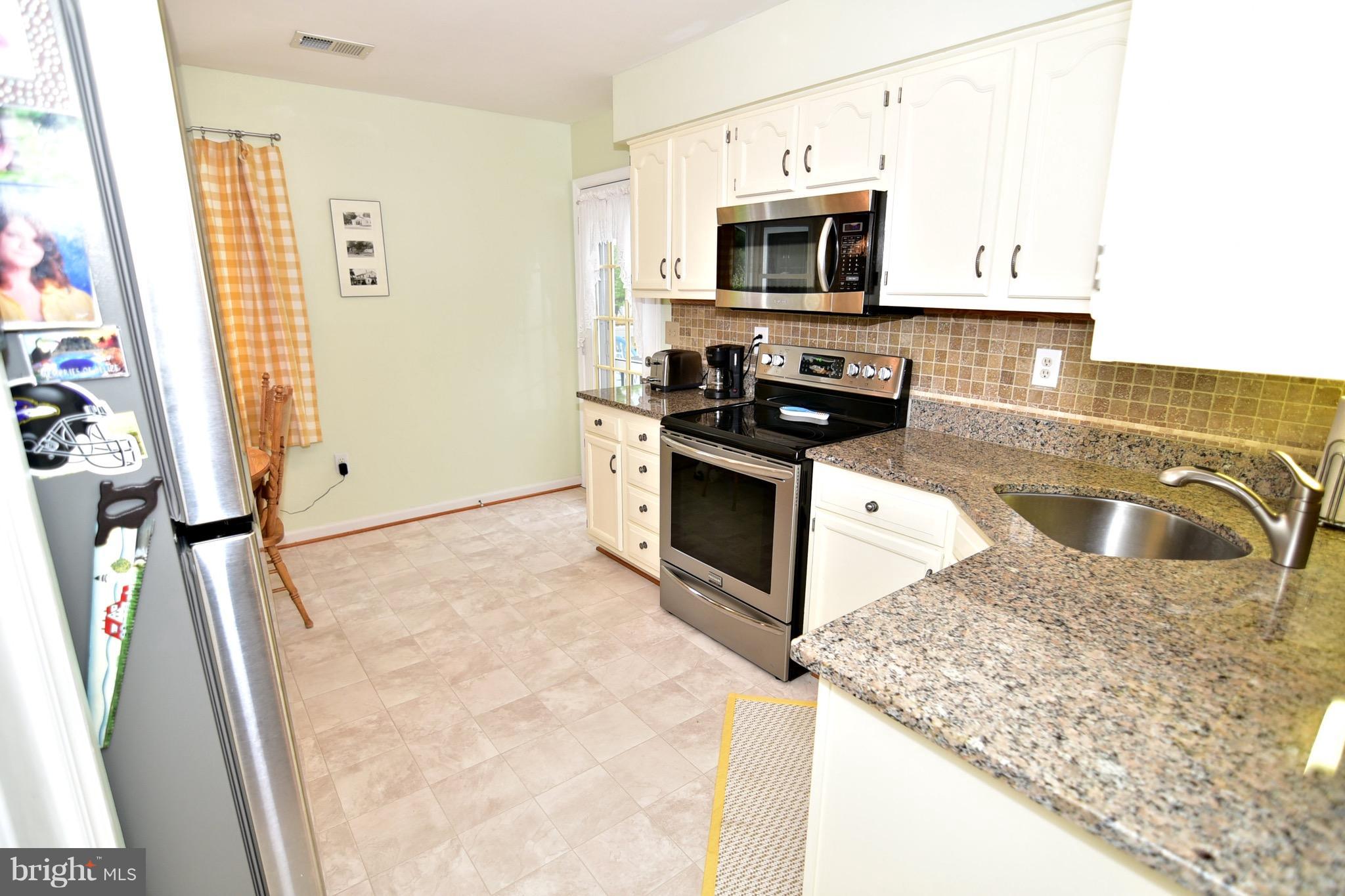 10836 Trinity Church Road Charlotte Hall, MD 20622 - Photo 14 of 30 Kitchen with granite and stainless appliances