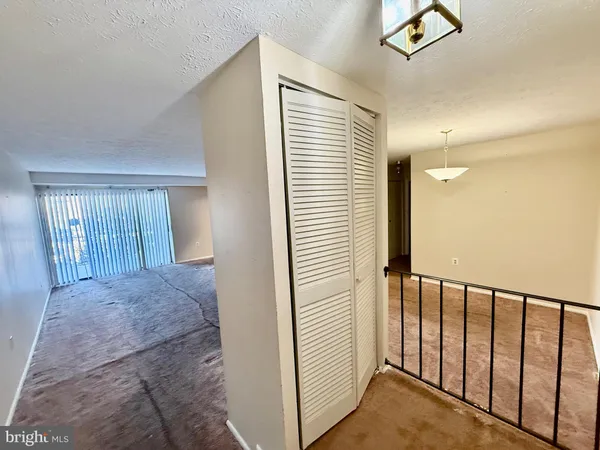 a view of a livingroom and a hallway