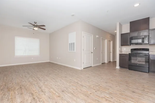 wooden floor in an empty room and a kitchen