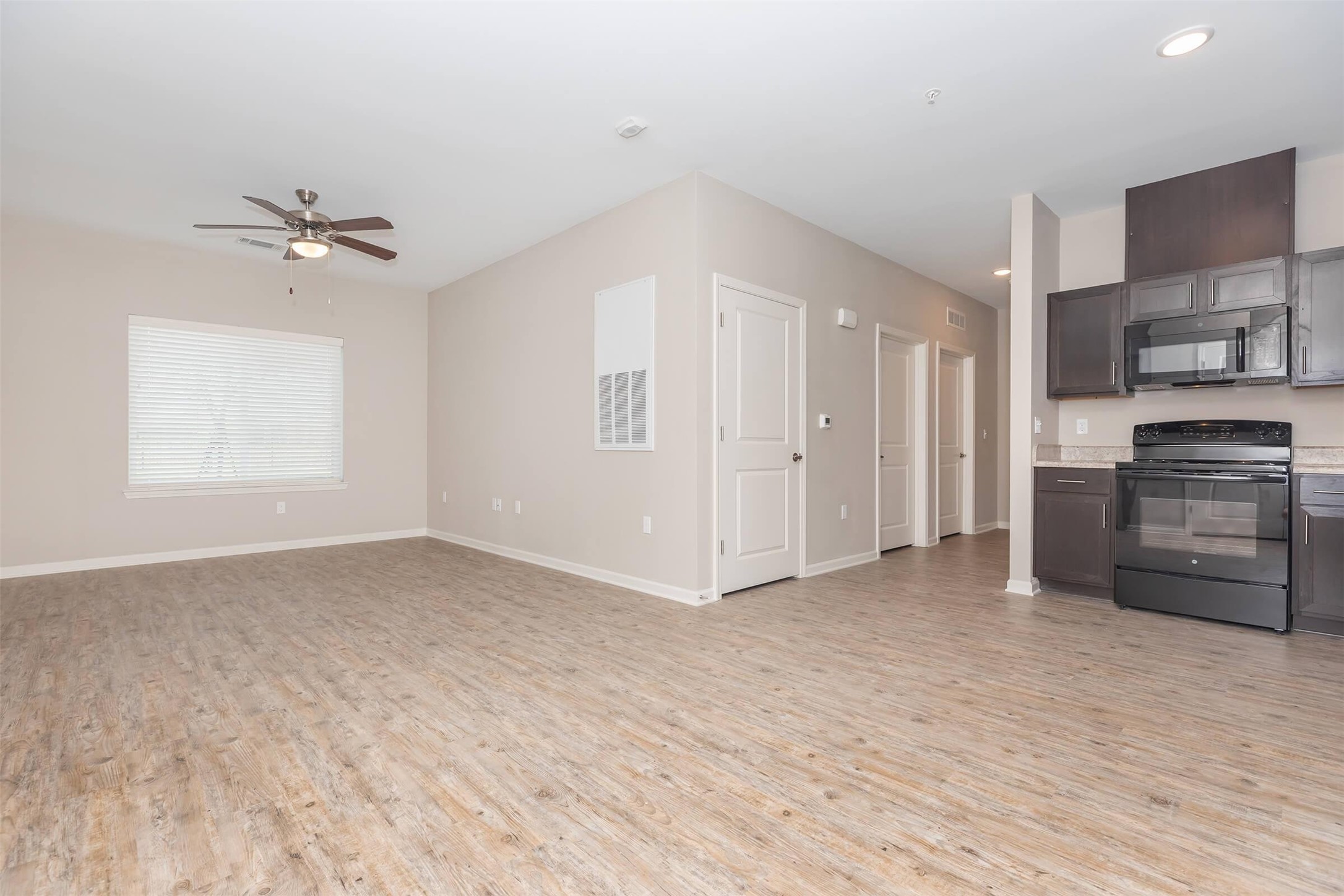 11777 Nicholson Drive Baton Rouge, LA 70810 - Photo 16 of 24 wooden floor in an empty room and a kitchen