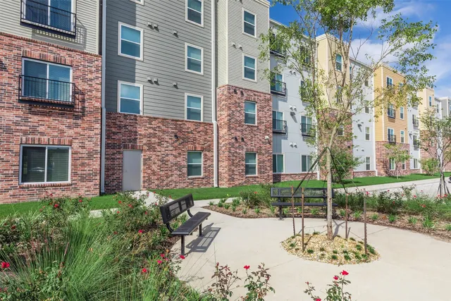 a view of a flower garden in front of a building