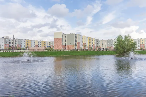 a view of a lake with houses in the back