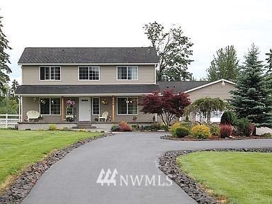 266 Woodard Road Chehalis, WA 98532 - Photo 1 of 1 a front view of a house with a garden and sitting area