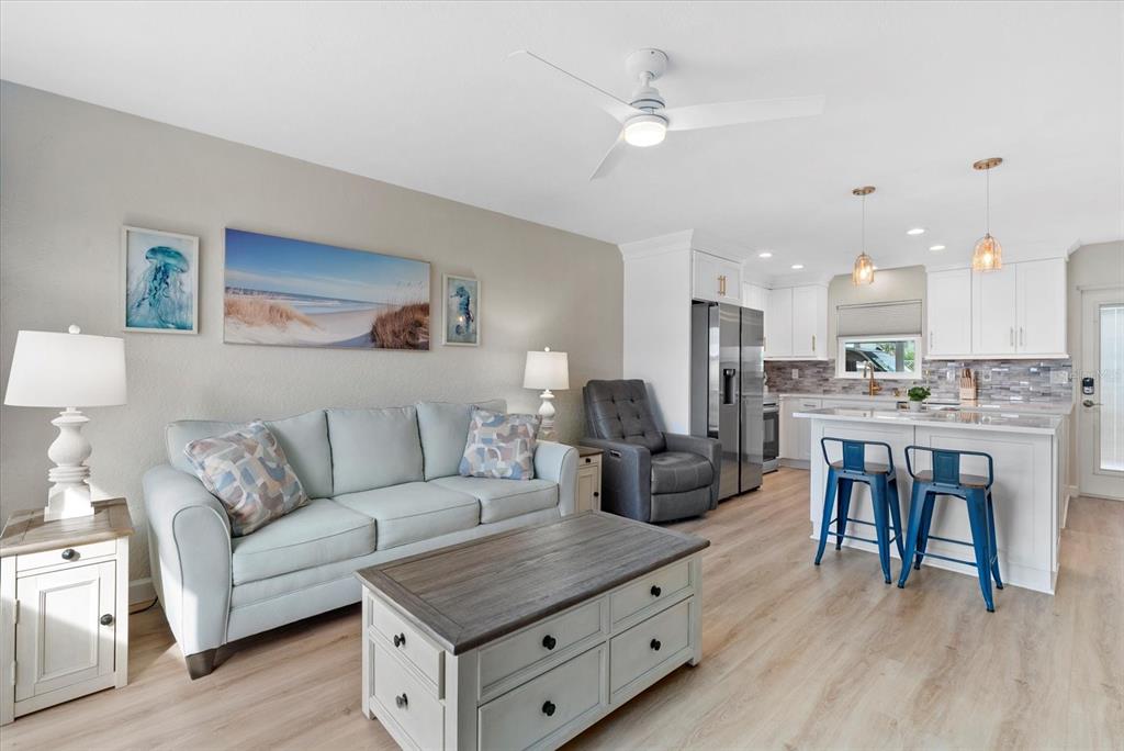 5830 Midnight Pass Road, Unit 25 Sarasota, FL 34242 - Photo 11 of 29 a living room with furniture and kitchen view