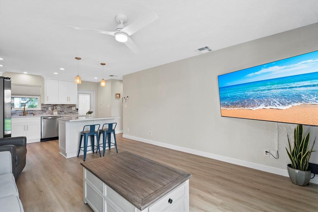5830 Midnight Pass Road, Unit 25 Sarasota, FL 34242 - Photo 12 of 29 a kitchen with a table and chairs in it