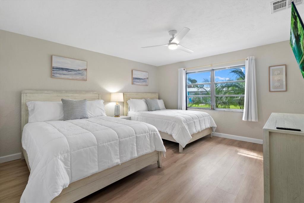 5830 Midnight Pass Road, Unit 25 Sarasota, FL 34242 - Photo 13 of 29 a bedroom with two beds and a window