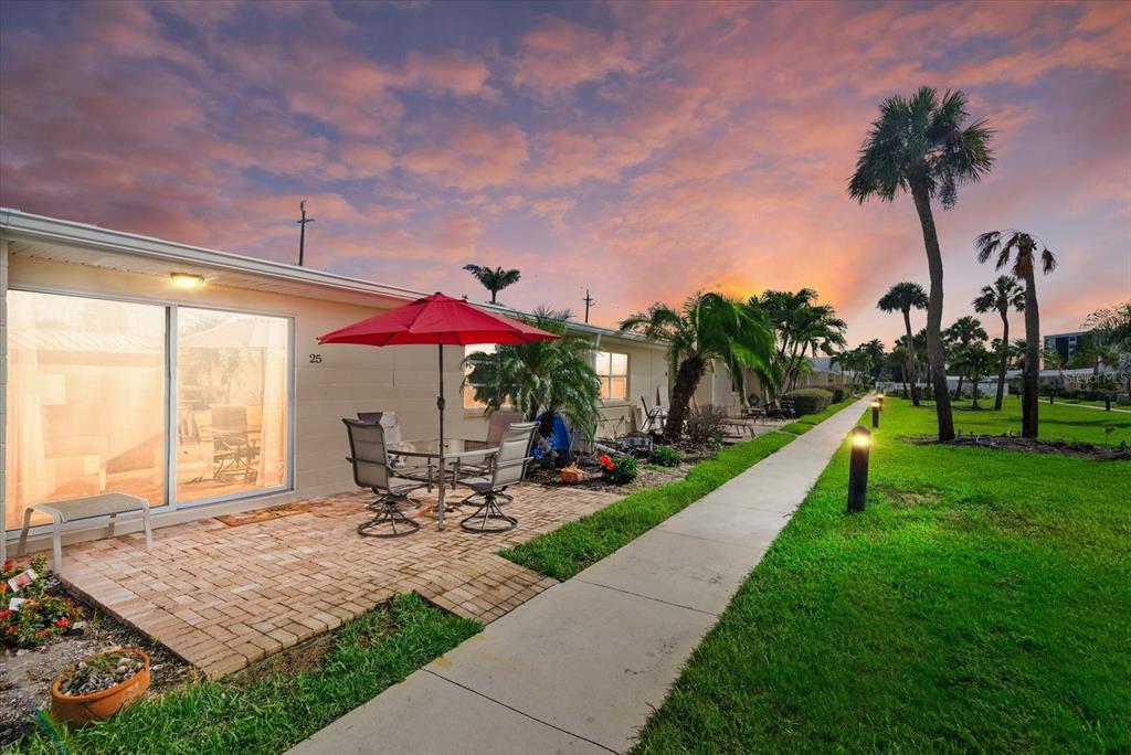 5830 Midnight Pass Road, Unit 25 Sarasota, FL 34242 - Photo 16 of 29 a view of a patio with a table and chairs