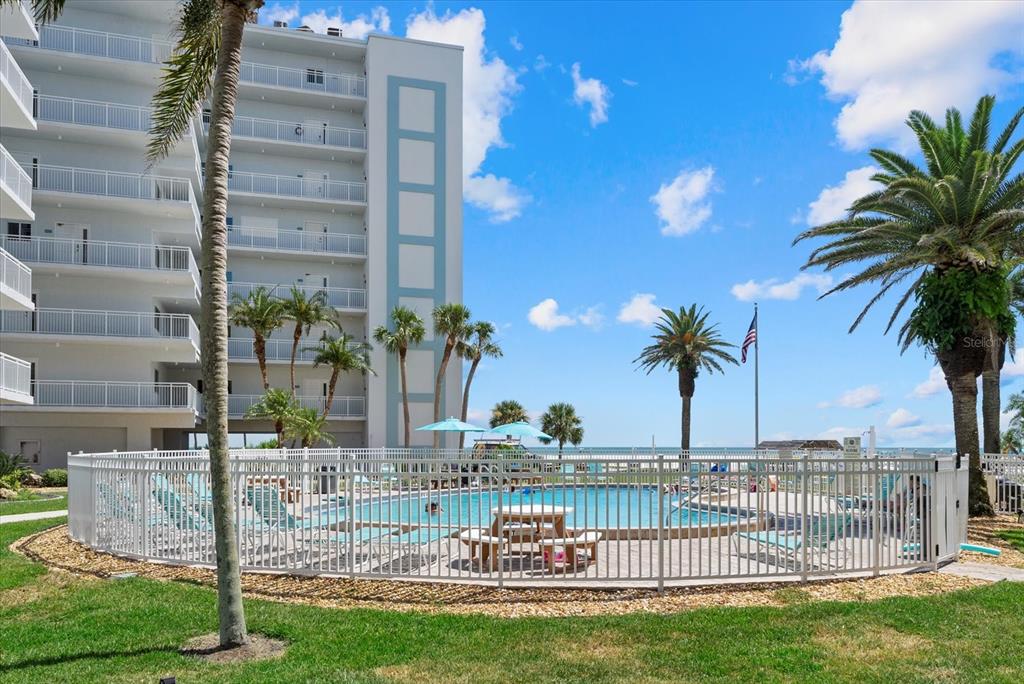 5830 Midnight Pass Road, Unit 25 Sarasota, FL 34242 - Photo 22 of 29 a view of outdoor space with swimming pool and trees in the background