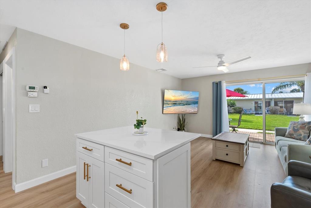 5830 Midnight Pass Road, Unit 25 Sarasota, FL 34242 - Photo 9 of 29 a room with furniture and a wooden floor