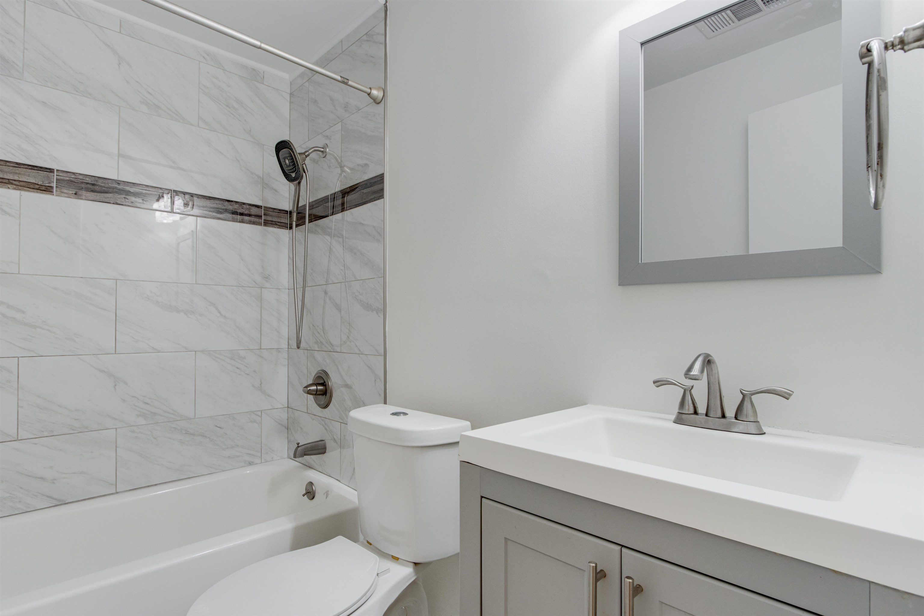 5418 Mesquite Road Memphis, TN 38120 - Photo 11 of 21 Full bathroom with tiled shower / bath, vanity, and toilet