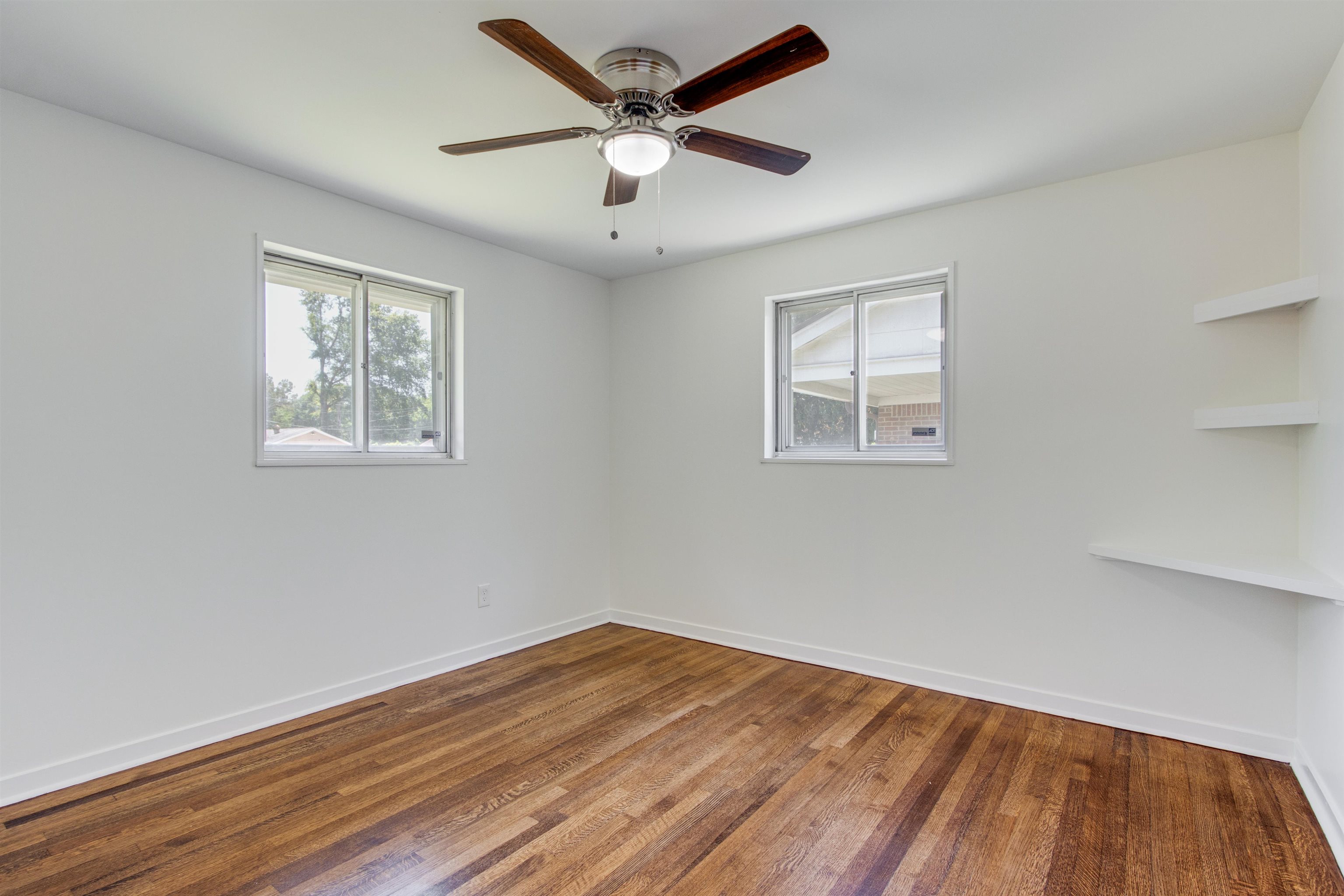 5418 Mesquite Road Memphis, TN 38120 - Photo 12 of 21 Unfurnished room featuring dark hardwood / wood-style flooring and ceiling fan