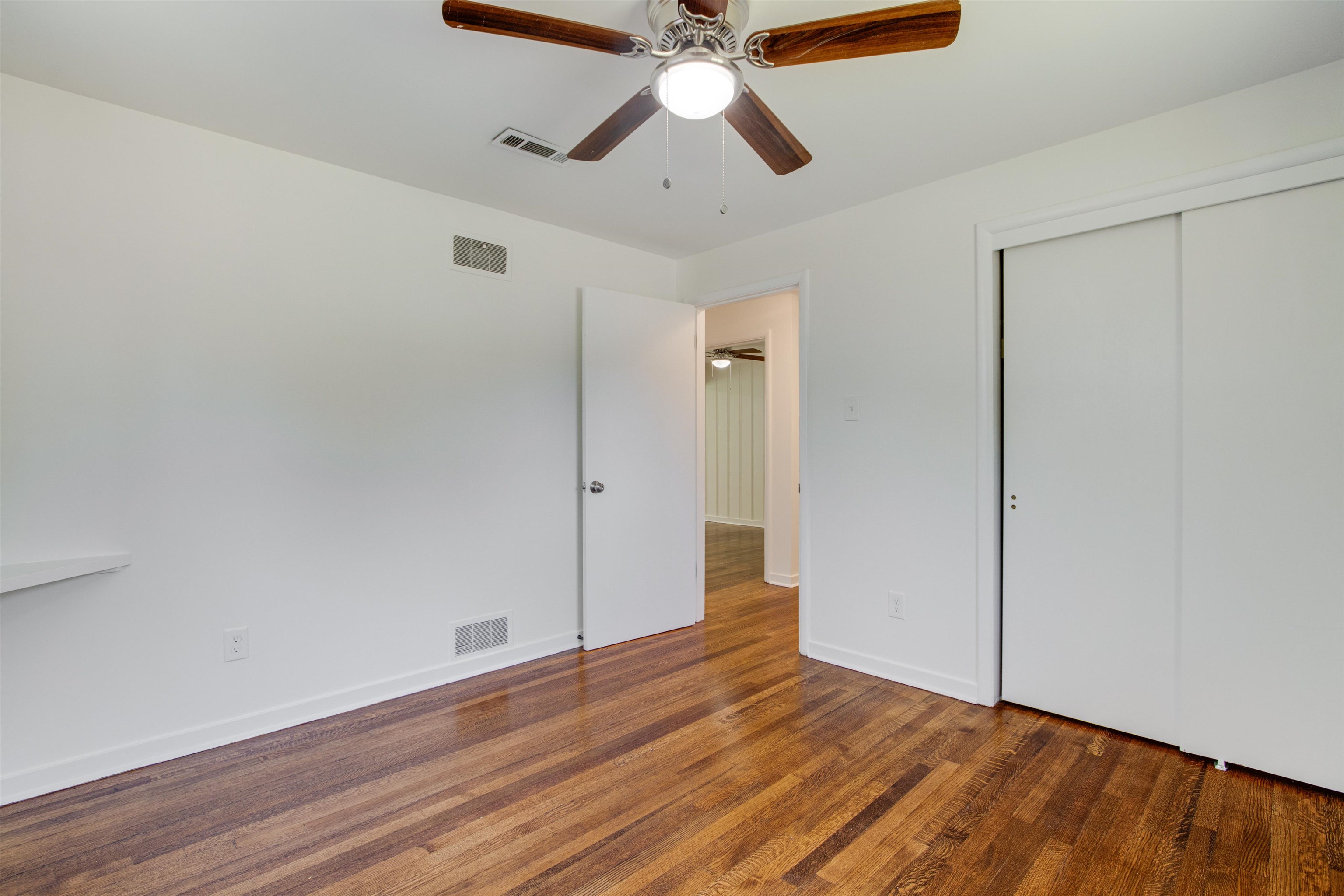 5418 Mesquite Road Memphis, TN 38120 - Photo 13 of 21 Unfurnished bedroom featuring dark wood-type flooring, a closet, and ceiling fan