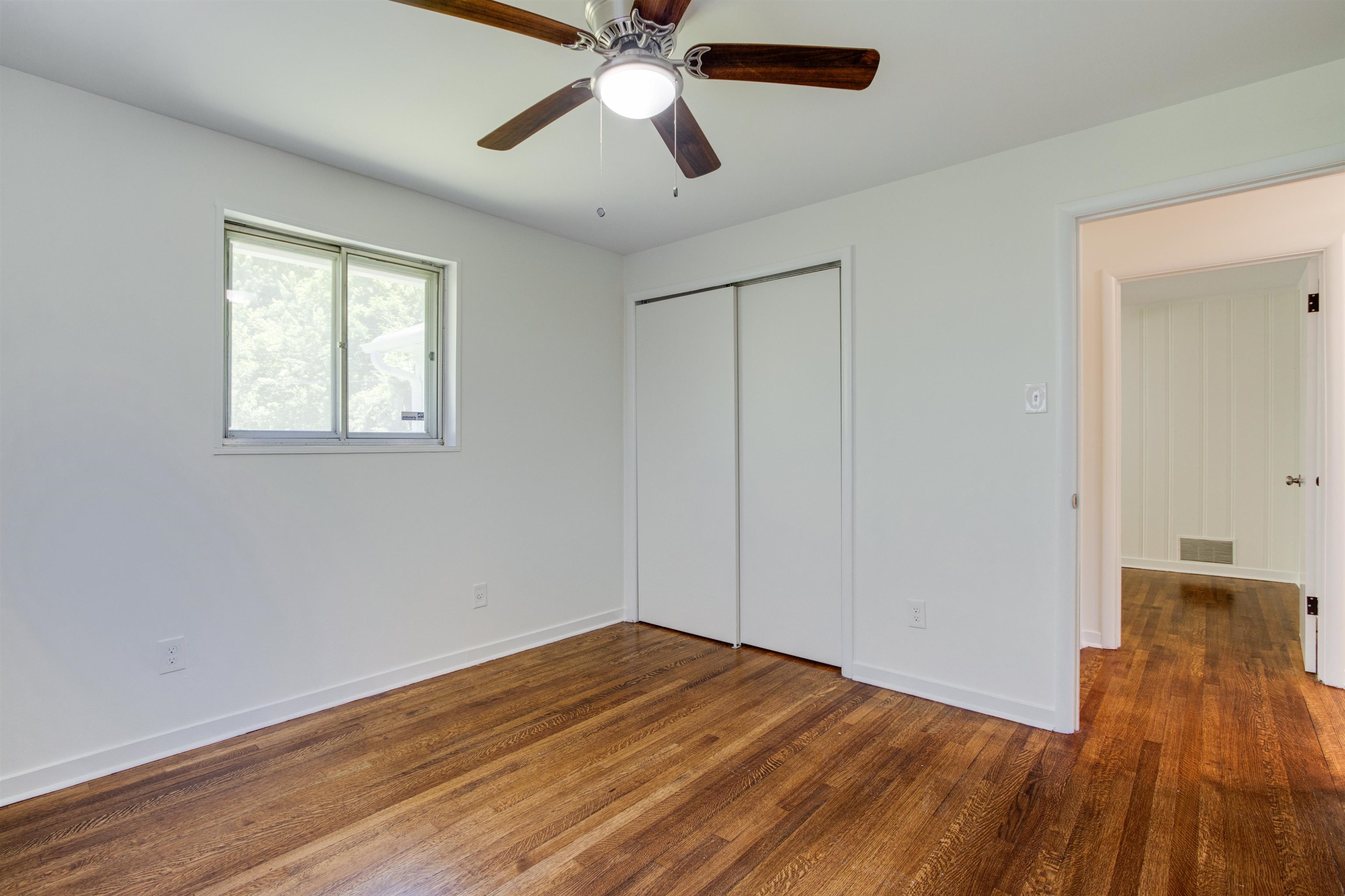 5418 Mesquite Road Memphis, TN 38120 - Photo 15 of 21 Unfurnished bedroom with dark hardwood / wood-style floors, ceiling fan, and a closet