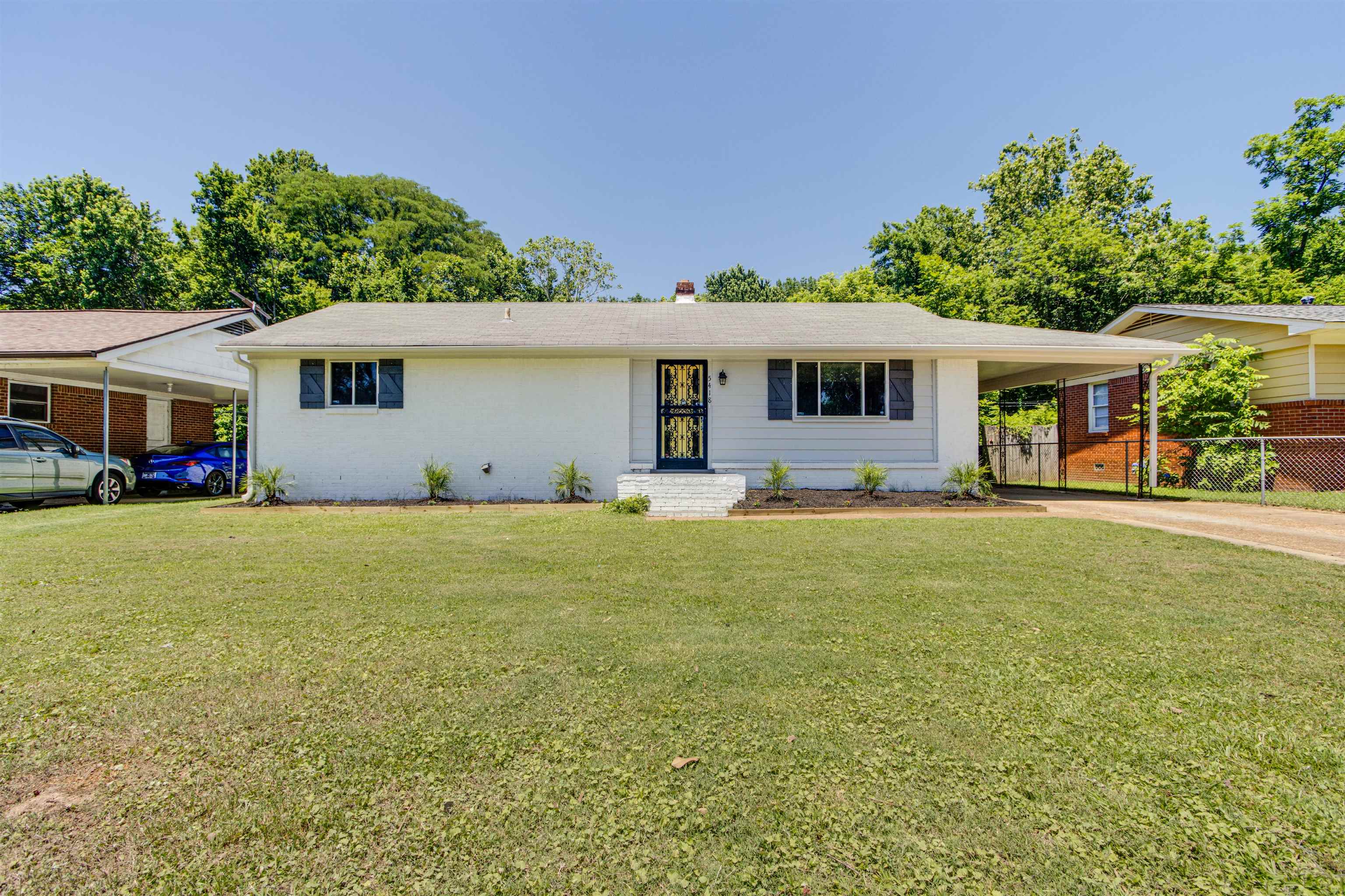 5418 Mesquite Road Memphis, TN 38120 - Photo 2 of 21 Ranch-style house featuring a front lawn and a carport