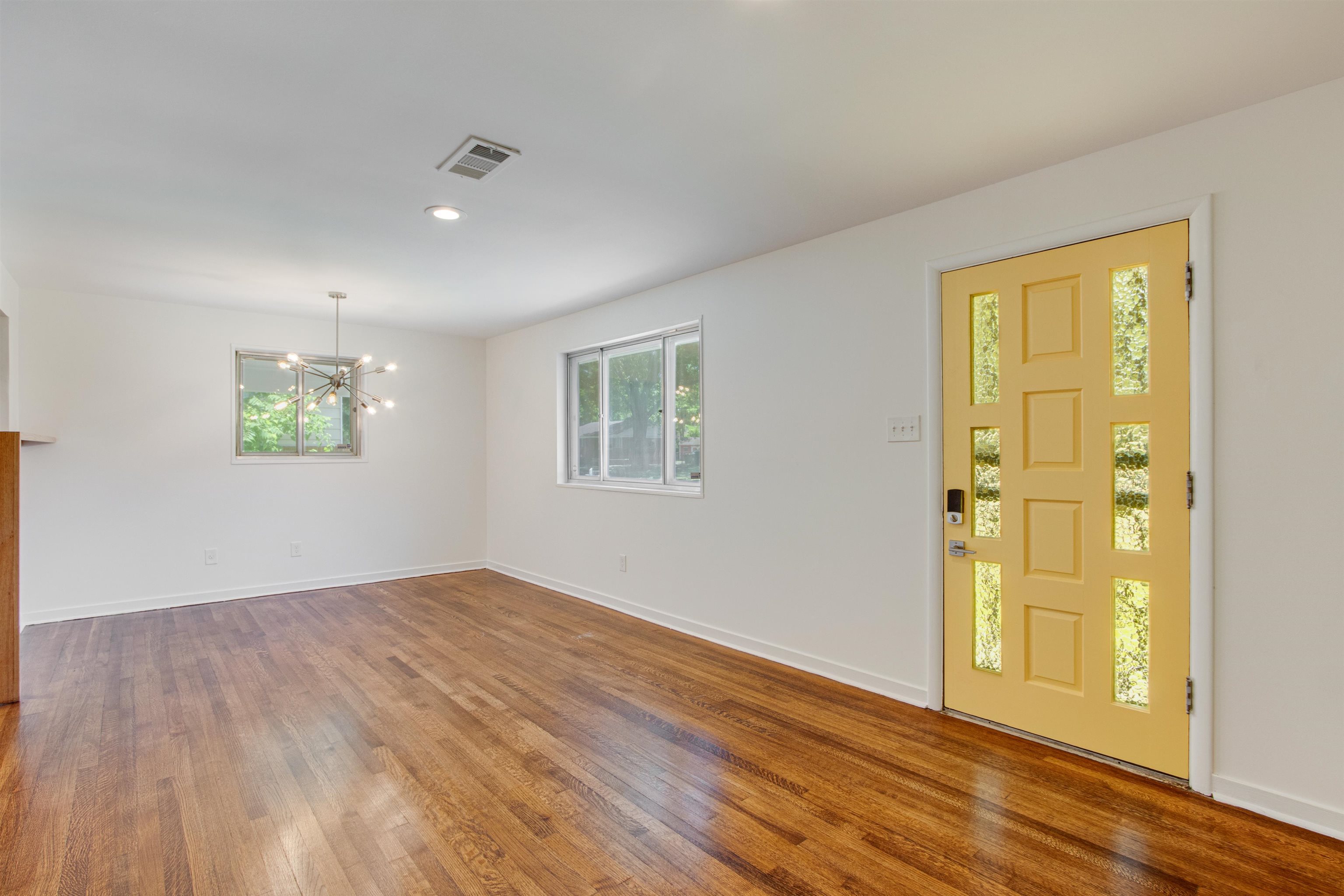 5418 Mesquite Road Memphis, TN 38120 - Photo 3 of 21 Foyer featuring a chandelier, a healthy amount of sunlight, and dark hardwood / wood-style flooring