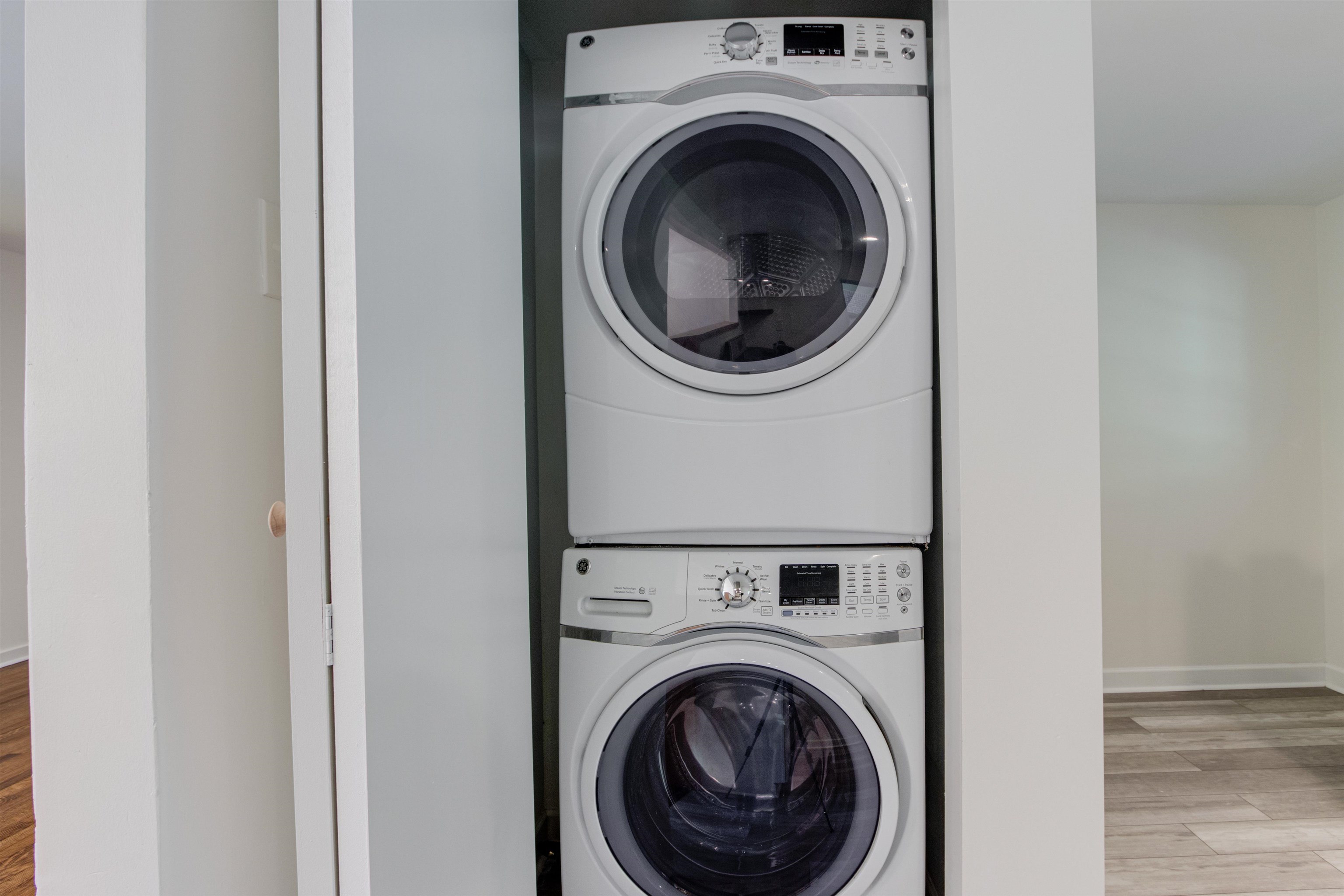 5418 Mesquite Road Memphis, TN 38120 - Photo 10 of 21 Laundry area featuring light hardwood / wood-style flooring and stacked washer / drying machine