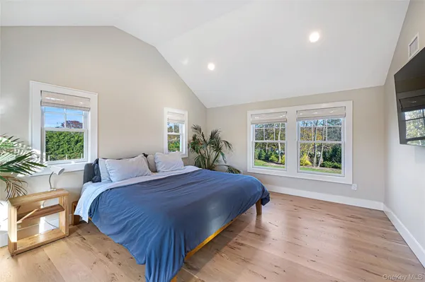 a bedroom with a large bed and a large window