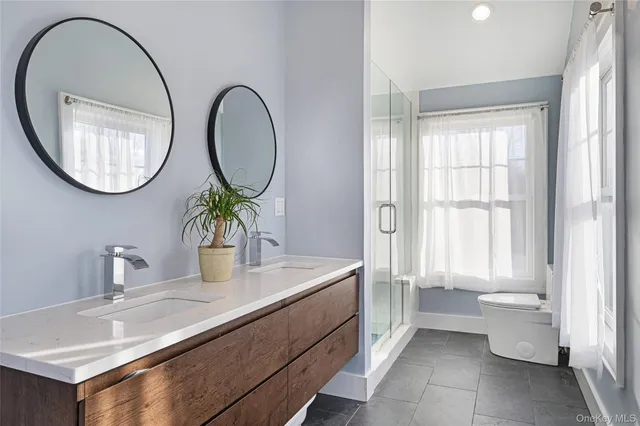 a bathroom with a granite countertop toilet a sink and a mirror