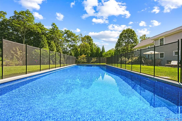 a view of a backyard with swimming pool