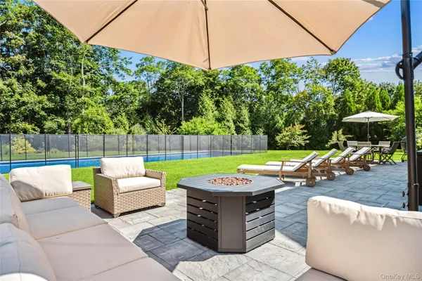 a view of a backyard with furniture and a fire pit