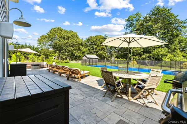 a view of an outdoor sitting area with furniture and umbrella