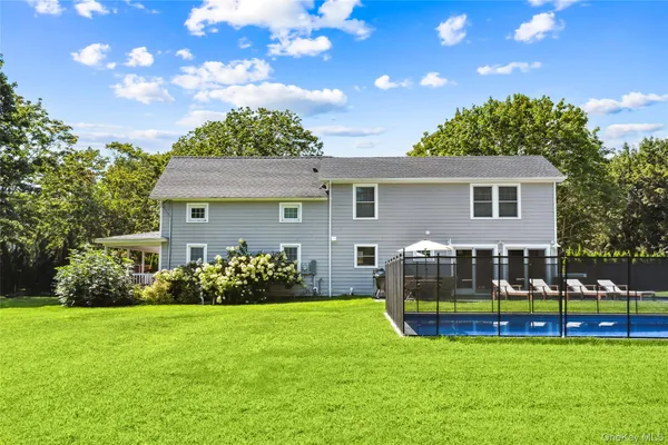 a front view of house with yard and outdoor seating