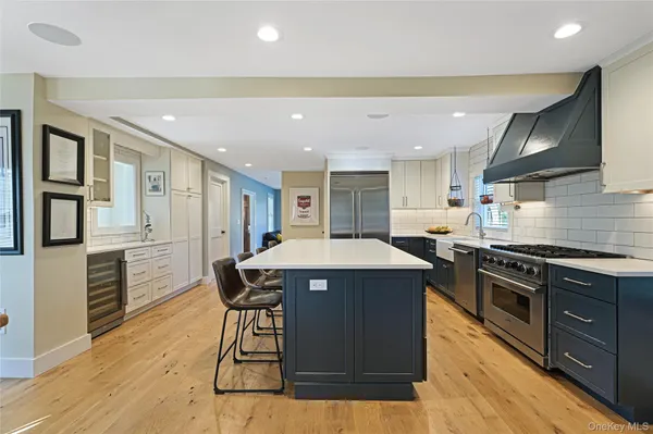 a kitchen with stainless steel appliances granite countertop a stove a sink dishwasher and a refrigerator
