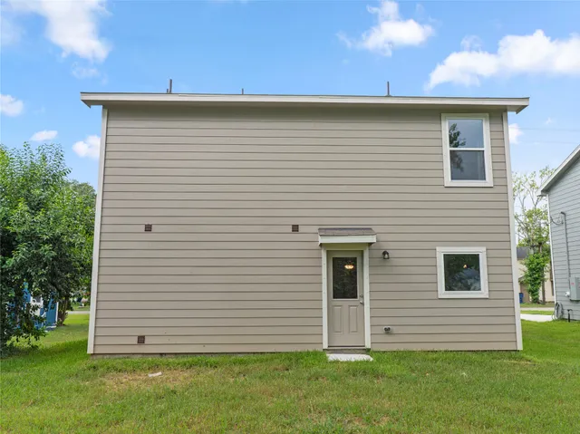 a view of a white house with a yard