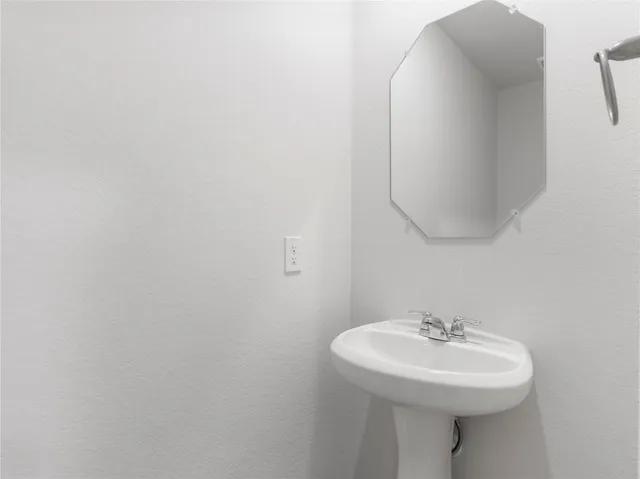 a bathroom with a sink a mirror and vanity