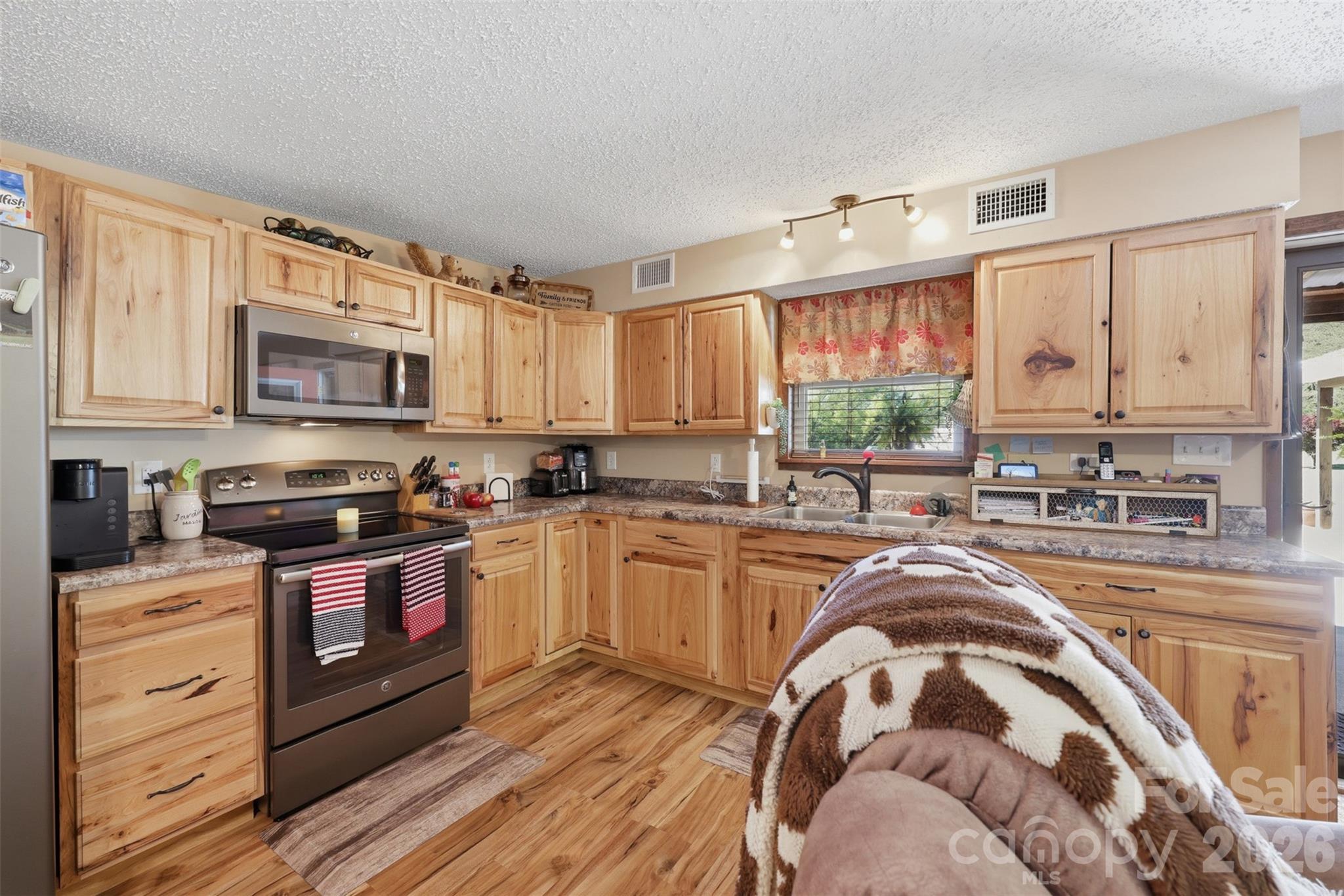 176-174 Oak Hollow Road Union Grove, NC 28689 - Photo 32 of 48 a kitchen with stainless steel appliances granite countertop a stove a sink and a microwave