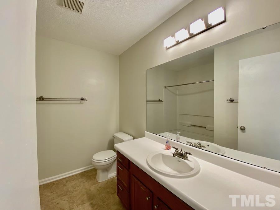 2126 Alpine Road Durham, NC 27707 - Photo 16 of 19 a bathroom with a sink a toilet and shower