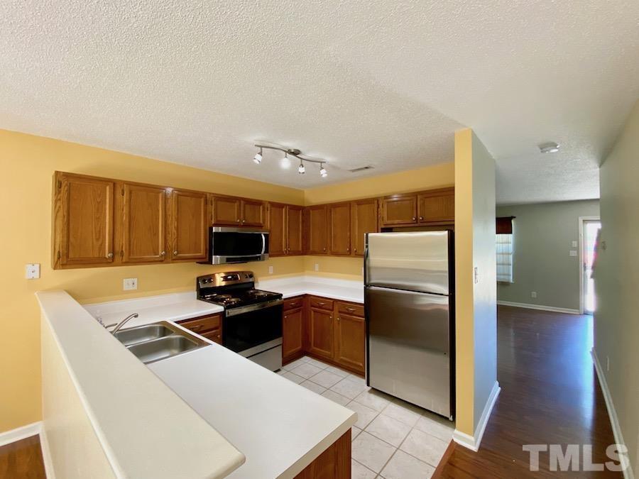 2126 Alpine Road Durham, NC 27707 - Photo 8 of 19 a kitchen with stainless steel appliances a stove a refrigerator and a sink