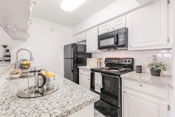 a kitchen with a stove and a microwave