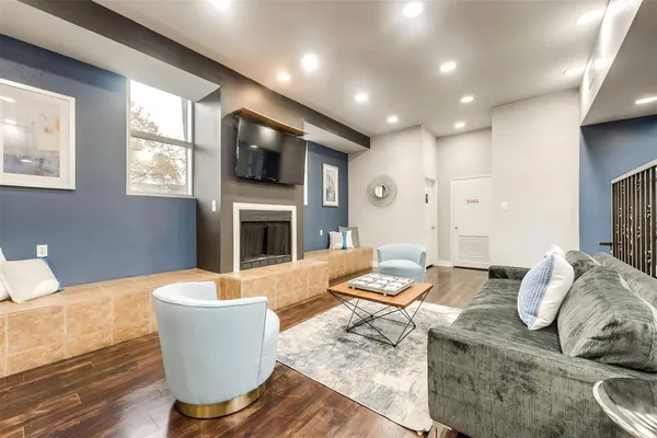 a living room with fireplace furniture and a flat screen tv