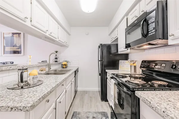 a kitchen with a sink stove and refrigerator
