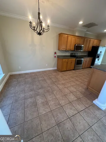 a kitchen with stainless steel appliances granite countertop a sink and cabinets