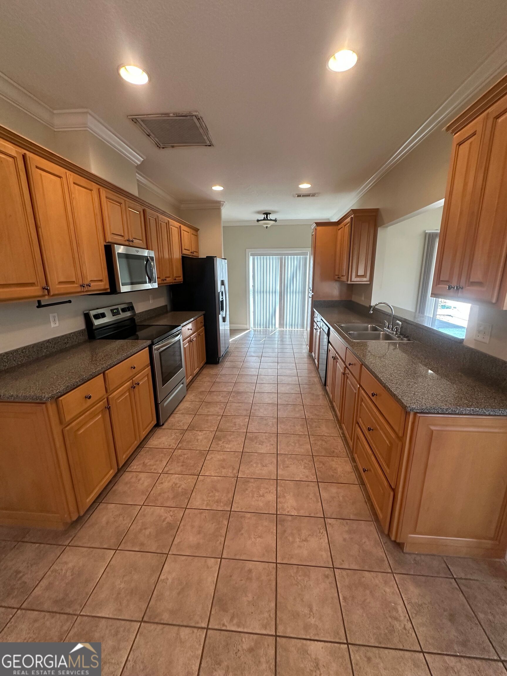 39 Coastal Walk St. Marys, GA 31558 - Photo 22 of 23 a kitchen with stainless steel appliances granite countertop a sink and cabinets