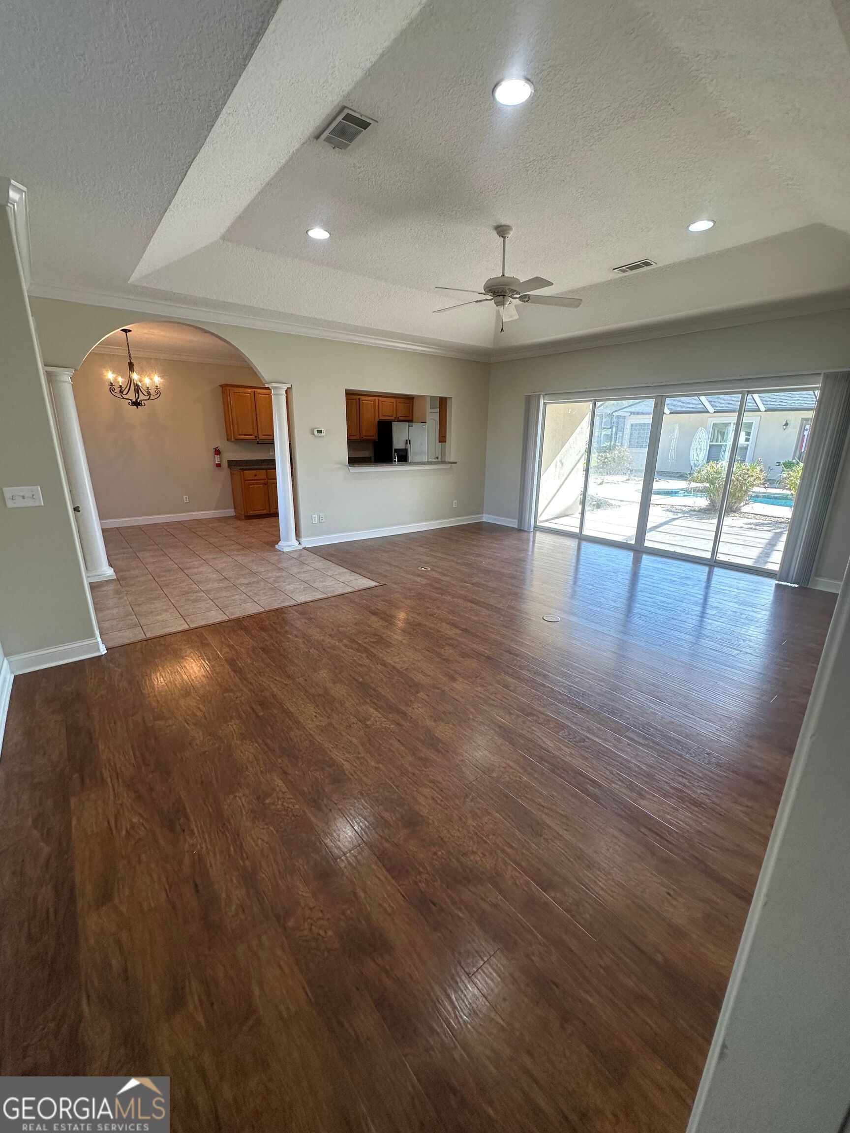 39 Coastal Walk St. Marys, GA 31558 - Photo 5 of 23 an empty room with wooden floor and windows