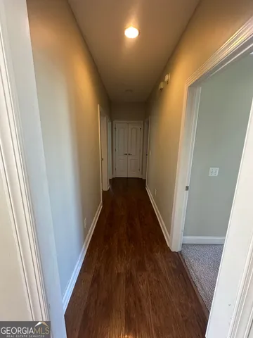 a view of a hallway with wooden floor