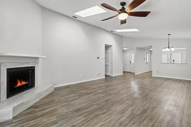 an empty room with a window and a fan