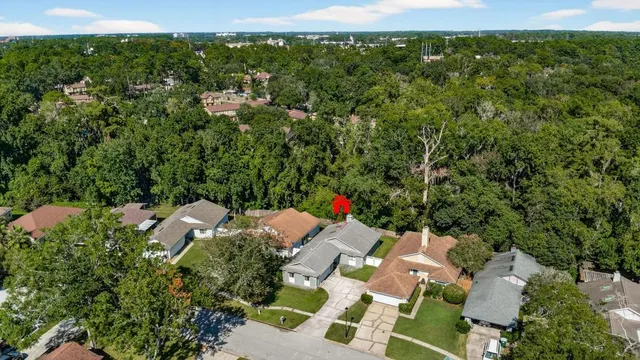 an aerial view of a house with a yard