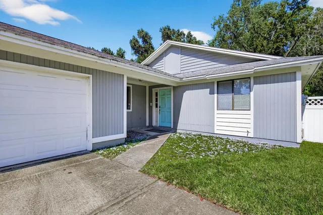 a view of a house with a small yard and plants
